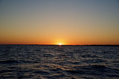 Scenic view of sea against clear sky during sunset