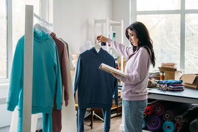 Small business owner, woman hold package box, receiving purchase order, working at office.