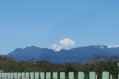 Scenic view of mountains against blue sky