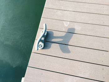 High angle view of shadow on wooden plank