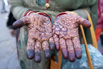Close-up of woman showing henna tattoo