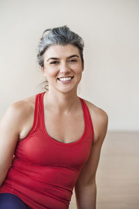 Portrait of happy woman performing yoga in gym