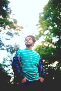 Low angle view of man against tree