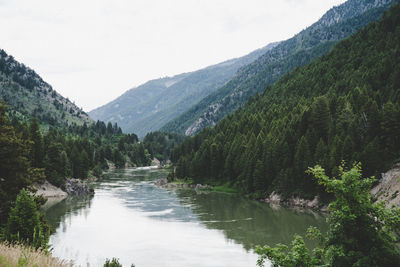 Scenic view of river amidst mountains against sky