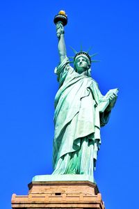 Low angle view of statue against blue sky