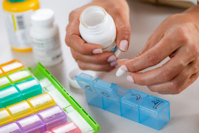 Cropped hand of person holding pills
