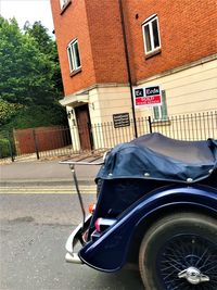 Car on street against buildings in city