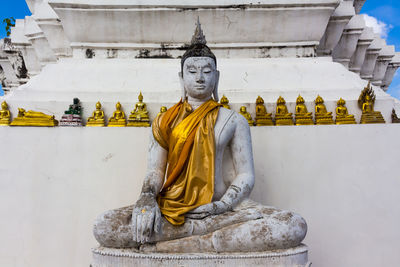 Statue of buddha against building