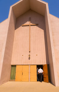 Full length of man outside temple against sky