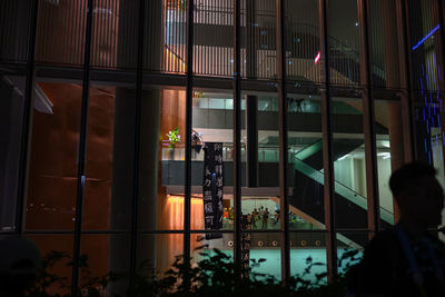 Reflection of building on glass window at night