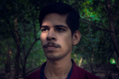 Portrait of young man in forest