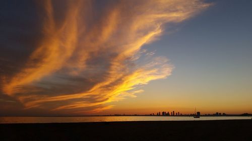 Scenic view of sea against orange sky