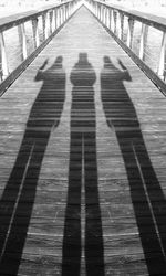 Shadow of railing on bridge