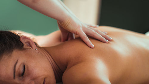 Relax massage for shoulders, hands of a massage therapist massaging shoulder of a female client