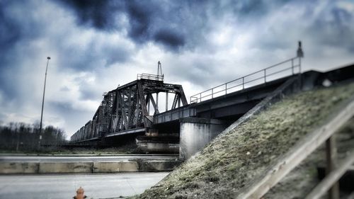 Low angle view of railway bridge against sky