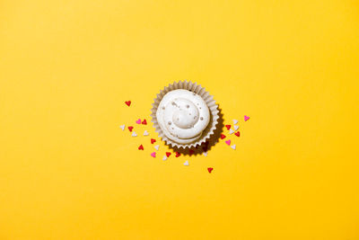 Close-up of cupcakes on yellow background