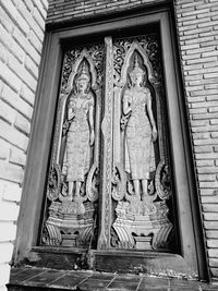 Low angle view of statue against temple