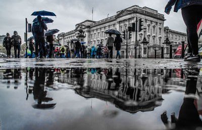 Reflection of people on wet street in rainy season