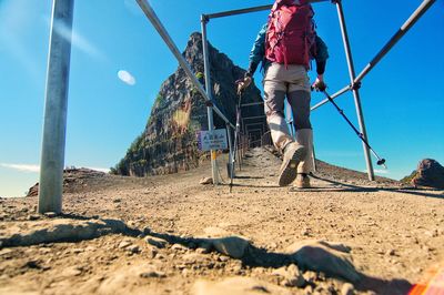 Rear view of woman on beach against clear sky