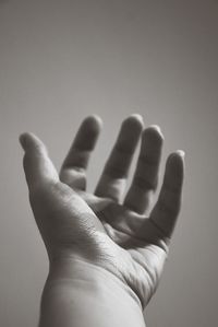 Close-up of human hand against gray background