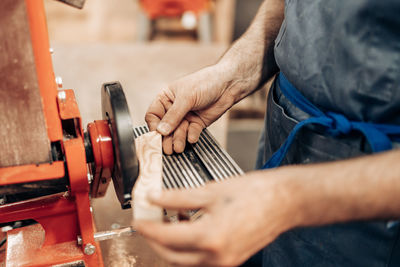 Midsection of carpenter working in workshop