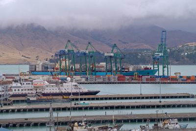 View of harbor against cloudy sky