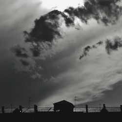 Low angle view of silhouette buildings against sky at sunset