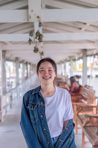 Portrait of smiling young woman standing outdoors