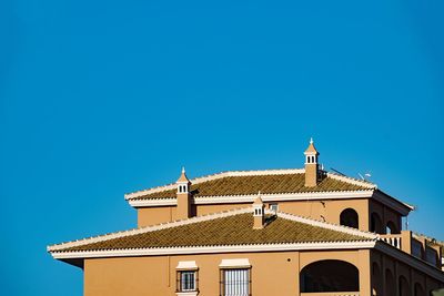 Low angle view of building against clear blue sky