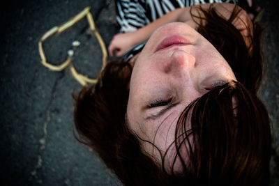 High angle view of woman sitting on road