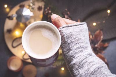Low section of person holding coffee cup
