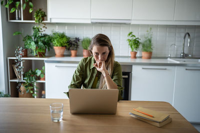 Busy accountant freelance woman working at home feeling upset with results of financial statement