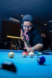 Portrait of woman playing pool