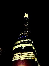 Low angle view of illuminated building at night