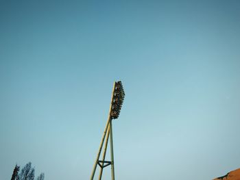 Low angle view of windmill against clear blue sky