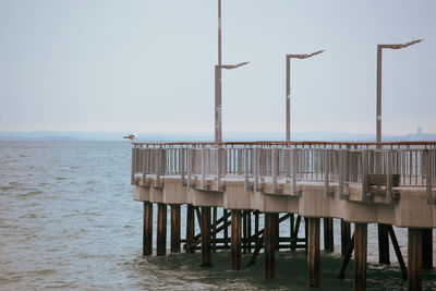 View of pier on sea against clear sky
