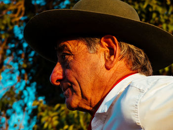 Close-up of man looking away while wearing hat