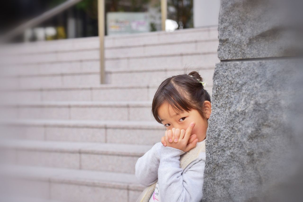 person, lifestyles, focus on foreground, childhood, casual clothing, leisure activity, boys, headshot, elementary age, built structure, front view, architecture, looking away, standing, wall - building feature, portrait, waist up, innocence