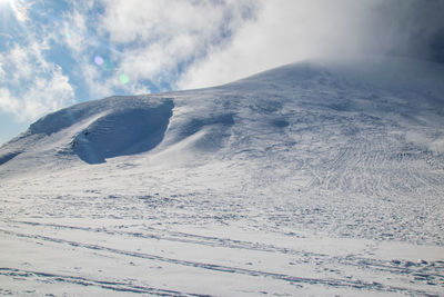 Scenic view of snow covered mountain against sky