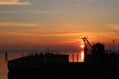 Silhouette sailboats on sea against sky during sunset