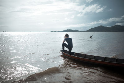 Man looking at sea against sky