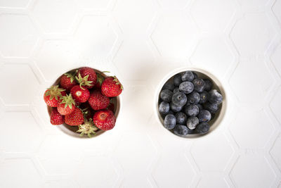 Frozen strawberries and blueberries covered with hoarfrost. berries are frozen.