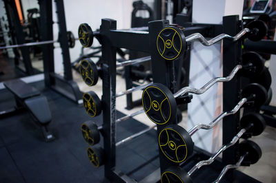 Close-up of barbells on rack in gym