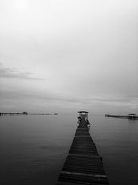 Pier over sea against sky