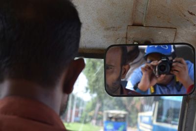 Rear view of man photographing with dog