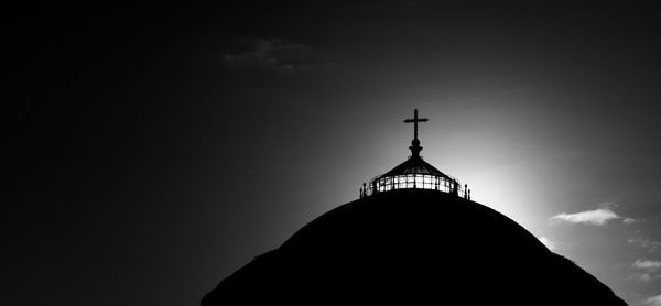 Low angle view of silhouette building against sky
