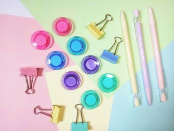 Directly above shot of school supplies on colored background