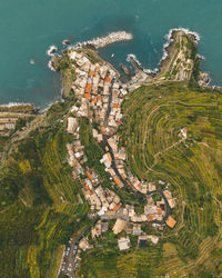 High angle view of buildings and sea in city