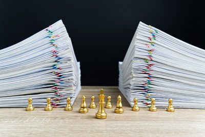 Close-up of books on table against black background