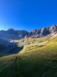 Scenic view of mountains against clear blue sky